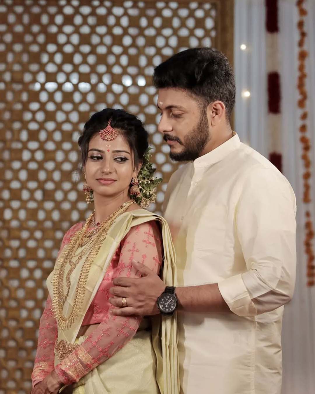 Couple in traditional attire posing for wedding photos